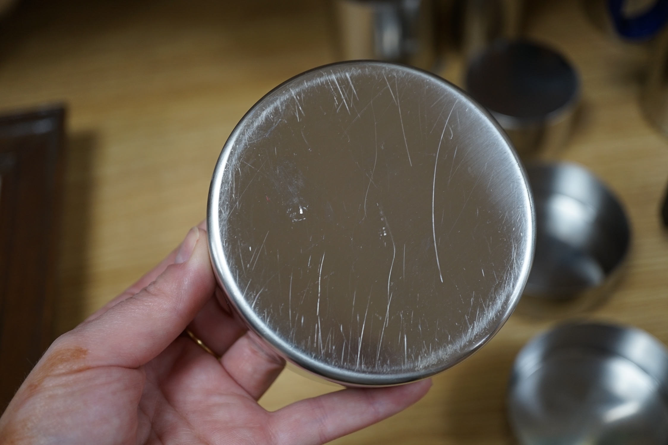 A thirteen piece suite of Arne Jacobsen stainless steel cylinder ware, coffee pot 24cm high